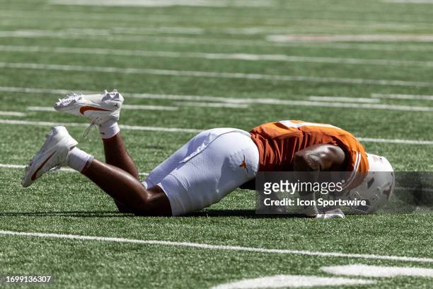 Texas Longhorns tight end Ja'Tavion Sanders lies on the ground in pain after his ankle gets rolled up onto during the Big 12 football game between...
