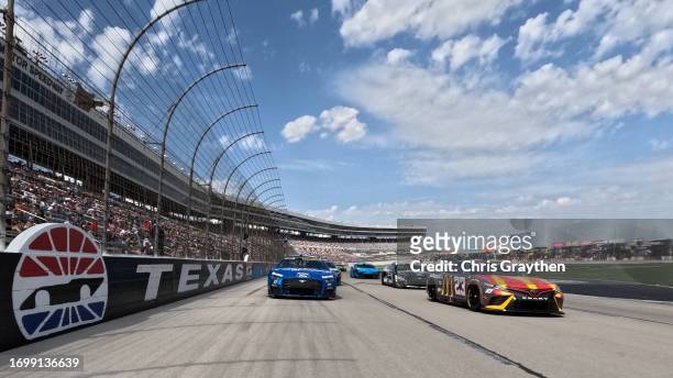Bubba Wallace, driver of the McDonald's Toyota, and Chris Buescher, driver of the Fastenal Ford, lead the field on a pace lap prior to the NASCAR Cup...
