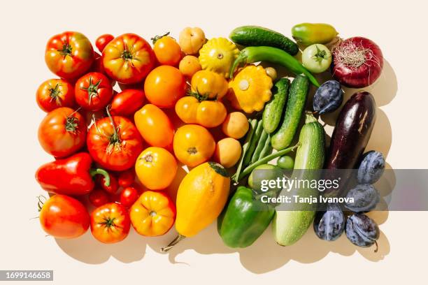 variety fresh of organic fruits and vegetables rainbow colors on beige background. healthy food, clean eating, diet and detox concept. flat lay, top view - colorful vegetables summer stock-fotos und bilder