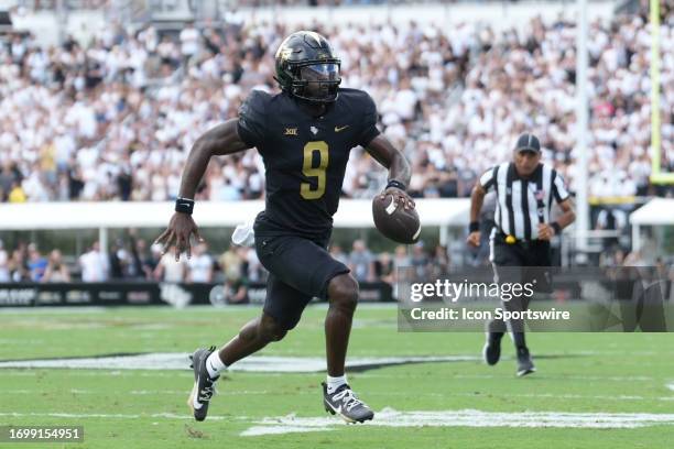 Knights quarterback Timmy McClain runs of toter corner of the end zone as he scrambles in the first half during the game between the Baylor Bears and...