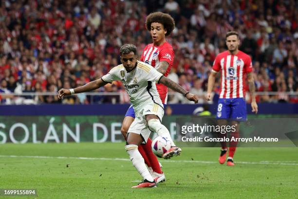 Rodrygo of Real Madrid shoots under pressure from Axel Witsel of Atletico Madrid during the LaLiga EA Sports match between Atletico Madrid and Real...