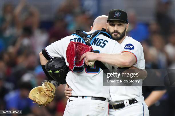 Jacob Stallings of the Miami Marlins embraces Tanner Scott after a game against the Milwaukee Brewers at loanDepot park on September 24, 2023 in...