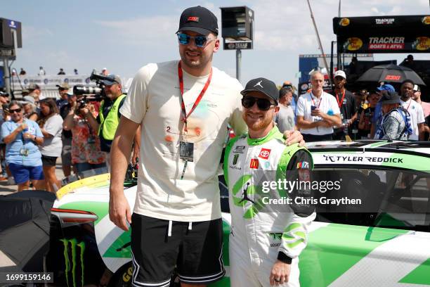 Player, Luka Doncic of the Dallas Mavericks and Tyler Reddick, driver of the Jordan Brand Toyota, pose for photos on the grid prior to the NASCAR Cup...