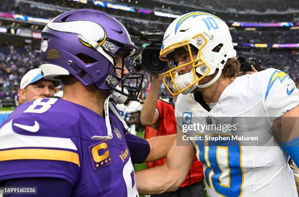 Kirk Cousins of the Minnesota Vikings and Justin Herbert of the Los Angeles Chargers hug after Los Angeles' 28-24 win at U.S. Bank Stadium on...