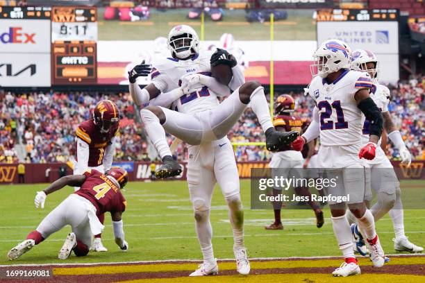 Micah Hyde of the Buffalo Bills picks up Tre'Davious White after White's interception in the fourth quarter of a game against the Washington...