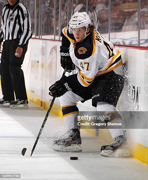 Torey Krug of the Boston Bruins moves the puck against the Pittsburgh Penguins in Game One of the Eastern Conference Final during the 2013 NHL...