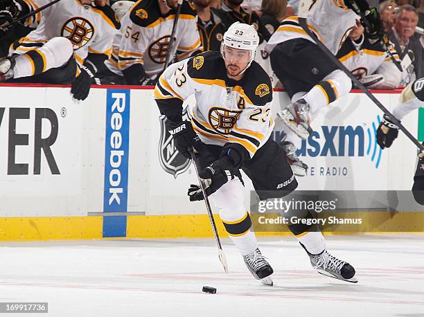 Chris Kelly of the Boston Bruins moves the puck against the Pittsburgh Penguins in Game One of the Eastern Conference Final during the 2013 NHL...