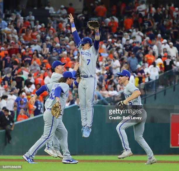 Bobby Witt Jr. #7 of the Kansas City Royals celebrates with Nick Pratto and Matt Duffy after defeating the Houston Astros 6-5 at Minute Maid Park on...