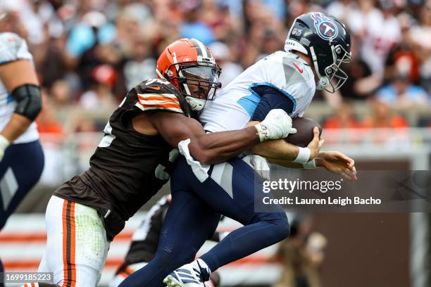 Myles Garrett of the Cleveland Browns sacks Ryan Tannehill of the Tennessee Titans during the game at Cleveland Browns Stadium on September 24, 2023...