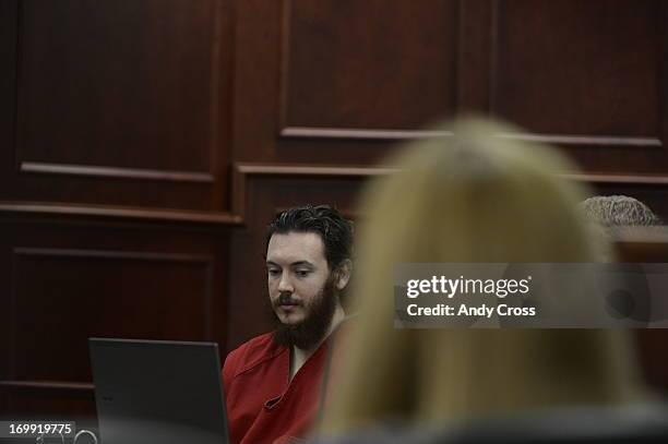 James Holmes stares blankly at advisement paperwork during a hearing Tuesday morning June 04, 2013 at the Arapahoe County Justice Center. Holmes is...