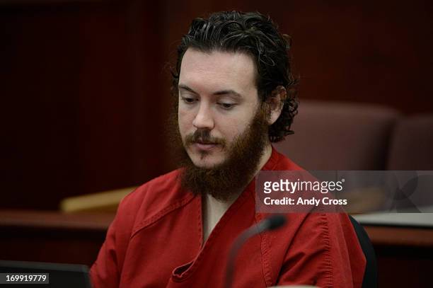James Holmes stares blankly at advisement paperwork during a hearing Tuesday morning June 04, 2013 at the Arapahoe County Justice Center. Holmes is...