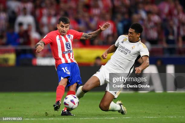 Angel Correa of Atletico Madrid is fouled by Jude Bellingham of Real Madrid during the LaLiga EA Sports match between Atletico Madrid and Real Madrid...