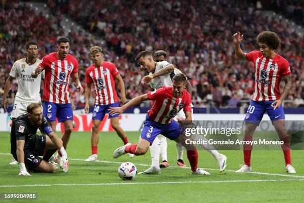 Cesar Azpilicueta of Atletico Madrid is challenged by Joselu of Real Madrid during the LaLiga EA Sports match between Atletico Madrid and Real Madrid...