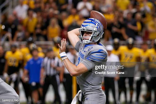 Quarterback Seth Henigan of the Memphis Tigers throws a pass during the first half against the Missouri Tigers at The Dome at Americas Center on...