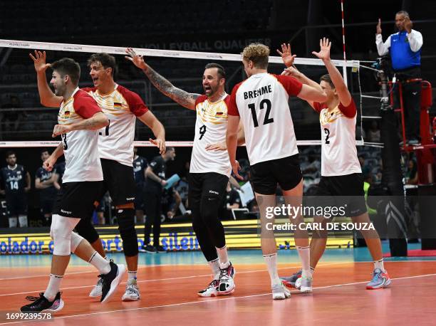 German players celebrate scoring a point during the Pool A Olympic qualifying tournament for the Paris 2024 volleyball match between Germany and Iran...