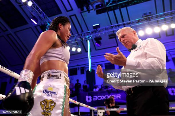 Magali Rodriguez is checked by the referee after being knocked down during the IBO Lightweight Title fight against Caroline Dubois at York Hall,...