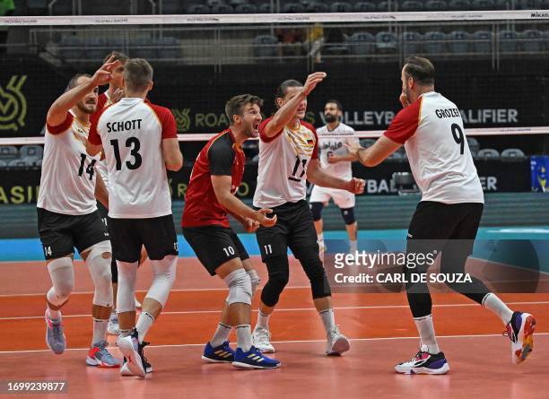 German players celebrate scoring a point during the Pool A Olympic qualifying tournament for the Paris 2024 volleyball match between Germany and Iran...