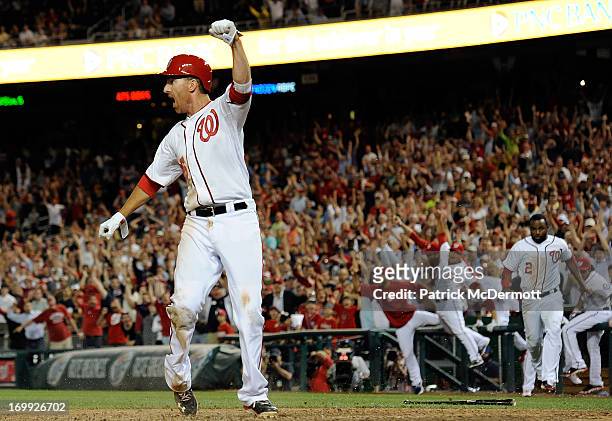 Adam LaRoche of the Washington Nationals celebrates after scoring the game winning run on a sacrifice fly by Stephen Lombardozzi in the ninth inning...