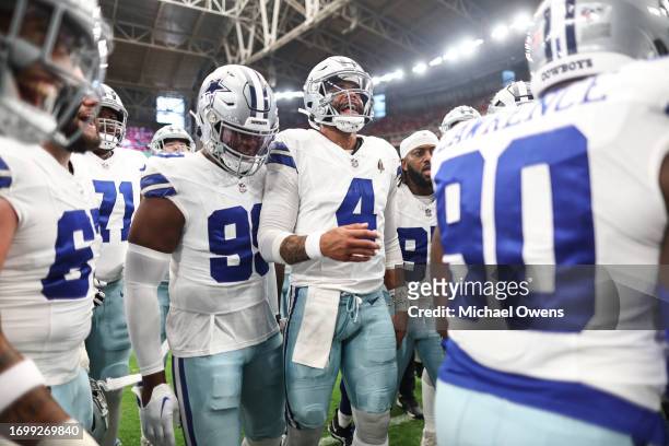 Dak Prescott of the Dallas Cowboys reacts in a huddle prior to an NFL football game between the Arizona Cardinals and the Dallas Cowboys at State...