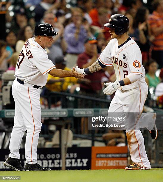 Brandon Barnes of the Houston Astros hits a home run in the sixth inning against the Baltimore Orioles as he receives congratulations from Dave...