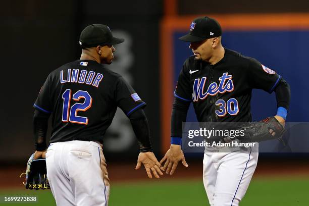 Rafael Ortega of the New York Mets and Francisco Lindor of the New York Mets celebrate after defeating the Philadelphia Phillies in game one of a...