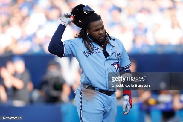 Vladimir Guerrero Jr. #27 of the Toronto Blue Jays takes off his helmet as he's called out on strikes in the fourth inning of their MLB game against...