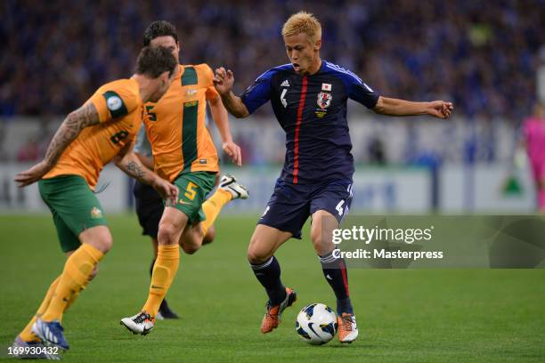 Keisuke Honda of Japan and Luke Wilkshire of Australia compete for the ball during the FIFA World Cup qualifier match between Japan and Australia at...