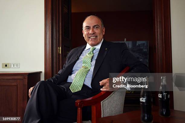 Muhtar Kent, chief executive officer of Coca-Cola Co., sits next to bottles of Coca-Cola soda during a Bloomberg Television interview in Yangon,...