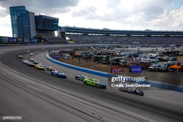 Denny Hamlin, driver of the FedEx Toyota, and Ryan Blaney, driver of the Menards/Dutch Boy Ford, race during the NASCAR Cup Series Autotrader...