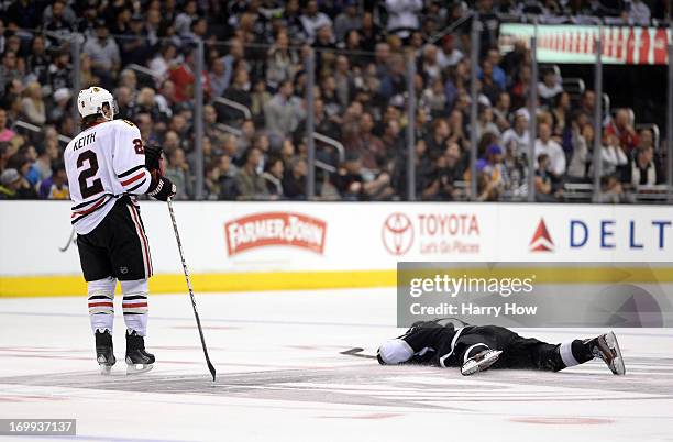 Duncan Keith of the Chicago Blackhawks skates to Jeff Carter of the Los Angeles Kings after Keith high sticked Carter on the face in the second...