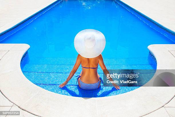 woman relaxing in a resort swimming pool - red tub 個照片及圖片檔
