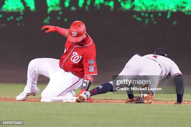 Lane Thomas of the Washington Nationals beats the tag by Orlando Arcia of the Atlanta Braves to steal second in the third inning during game two of a...