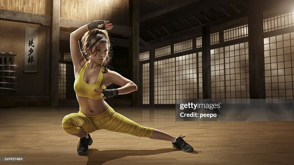 Girl Practising Martial Arts in Dojo