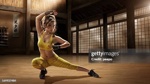 girl practising martial arts in dojo - karate woman stock pictures, royalty-free photos & images