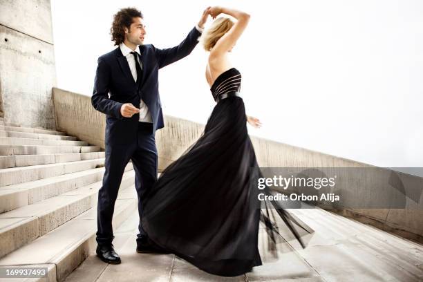 elegant couple dancing together - high fashion clothing stock pictures, royalty-free photos & images