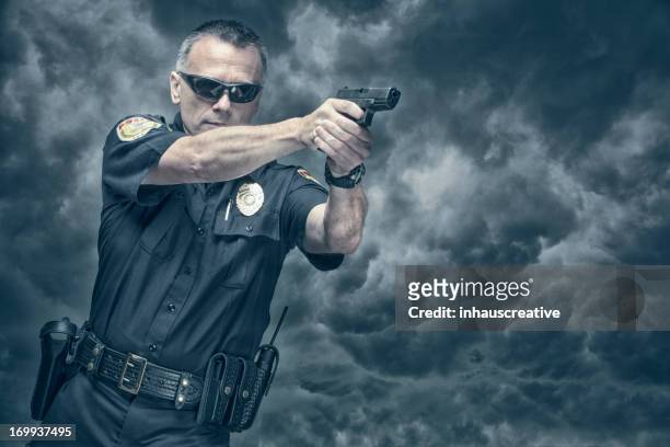 policeman shooting his pistol - shooting a weapon stock pictures, royalty-free photos & images