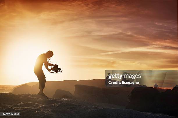 cameraman at sunset - filming bildbanksfoton och bilder