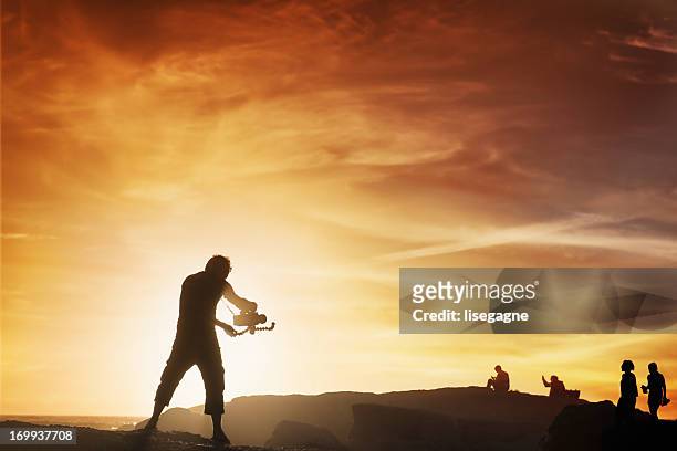 videographer at sunset - film crew outside stock pictures, royalty-free photos & images