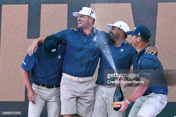 Bryson DeChambeau, Anirban Lahiri, Charles Howell III, and Paul Casey celebrate after the LIV Golf Invitational - Chicago at Rich Harvest Farms on...