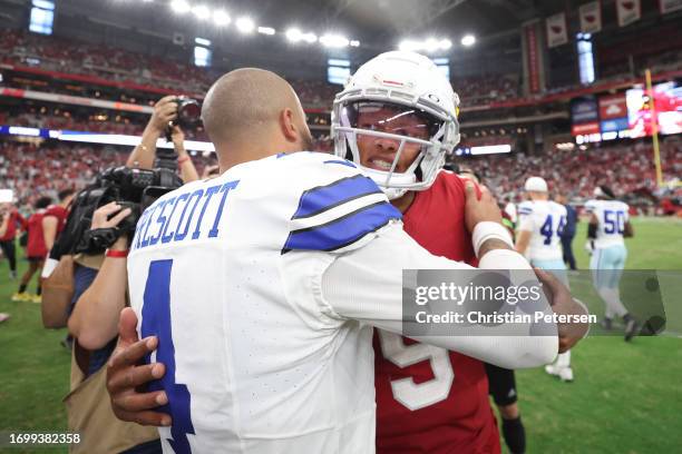 Dak Prescott of the Dallas Cowboys embraces Joshua Dobbs of the Arizona Cardinals following the game at State Farm Stadium on September 24, 2023 in...