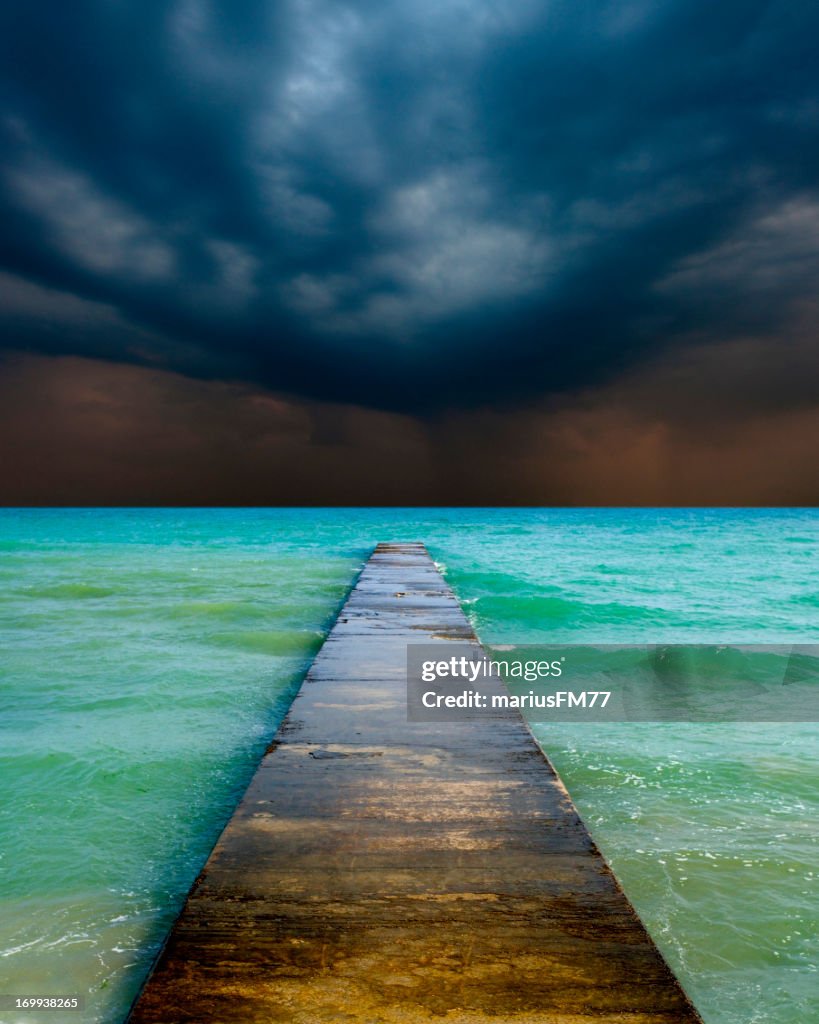 Stormy cloudy sky and empty jetty