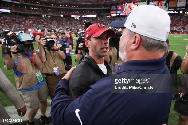 Head coach Jonathan Gannon of the Arizona Cardinals embraces Head coach Mike McCarthy of the Dallas Cowboys following the game at State Farm Stadium...