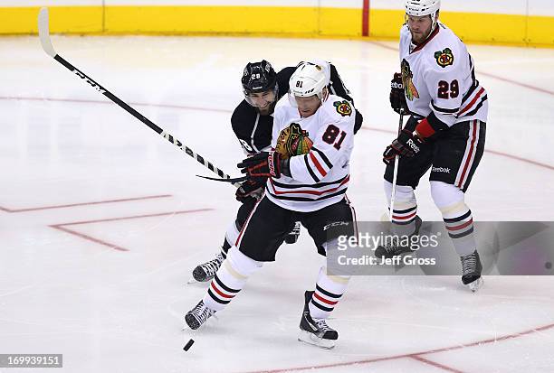Marian Hossa of the Chicago Blackhawks and Slava Voynov of the Los Angeles Kings vie for the puck in the first period of Game Three of the Western...