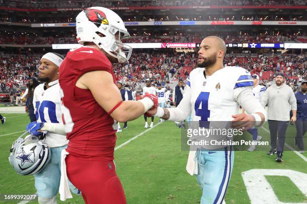 Dak Prescott of the Dallas Cowboys embraces Zach Ertz of the Arizona Cardinals following the game at State Farm Stadium on September 24, 2023 in...
