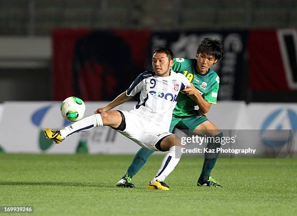 Tomoyuki Arata of Fagiano Okayama and Tsukasa Masuyama of FC Gifu compete for the ball during the J.League second division match between FC Gifu and...