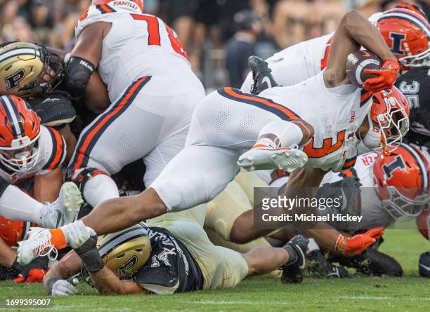 Yanni Karlaftis of the Purdue Boilermakers reaches to make the tackle on fourth down on Kaden Feagin of the Illinois Fighting Illini at Ross-Ade...