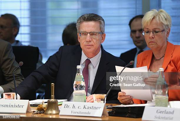 German Defense Minister Thomas de Maiziere sits down to answer questions from parliamentarians at the Bundestag defense commission as commission...