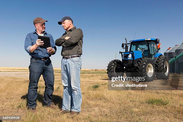 farmers and technology - concerned farmers stock pictures, royalty-free photos & images