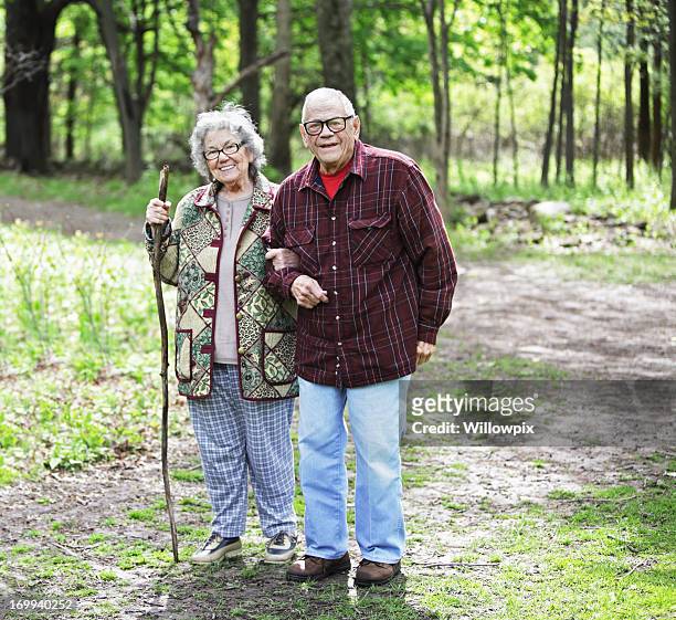 senior couple portrait on nature trail - grandma cane stock pictures, royalty-free photos & images