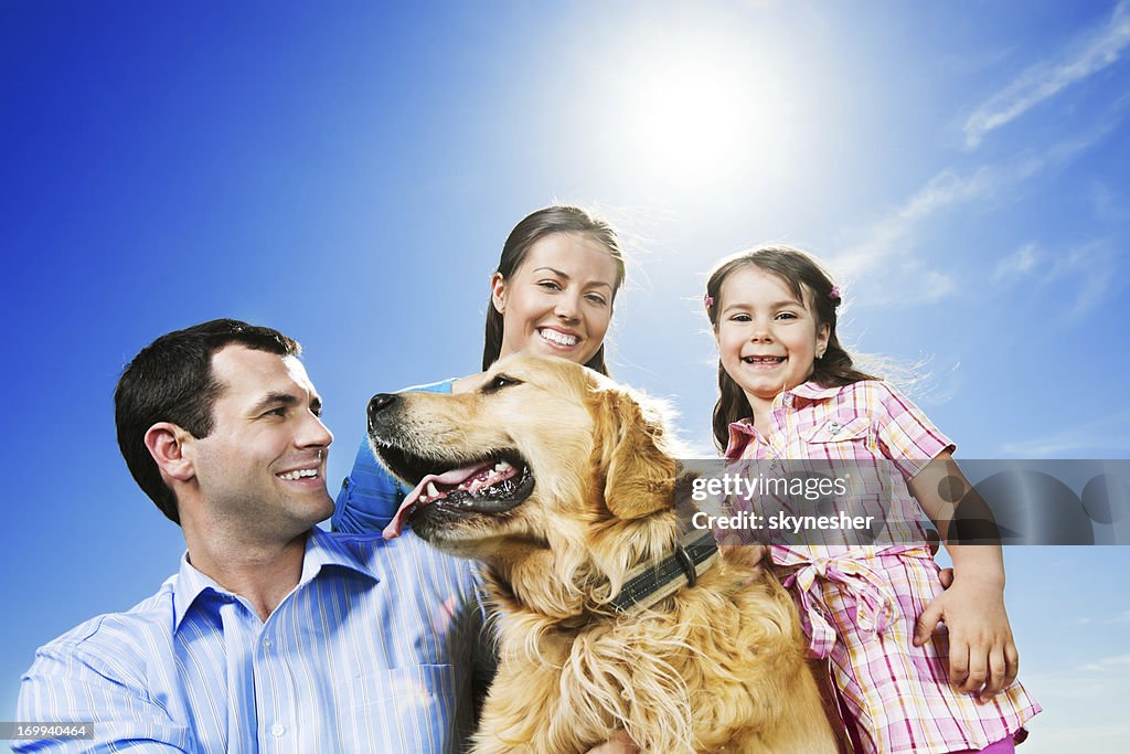 Happy family in the park with their dog